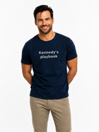 Man wearing a navy blue t-shirt with 'Kennedy's playbook' text, on a white background