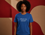 Person wearing a blue t-shirt with text in front of a geometric patterned background