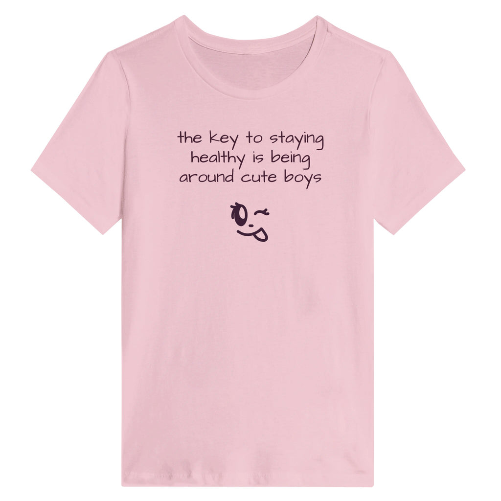 Pink t-shirt with humorous text and emoji on a white background