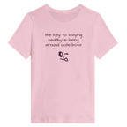 Pink t-shirt with humorous text and emoji on a white background