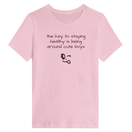 Pink t-shirt with humorous text and emoji on a white background