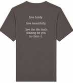 Dark gray t-shirt with motivational quote on the back against a white background
