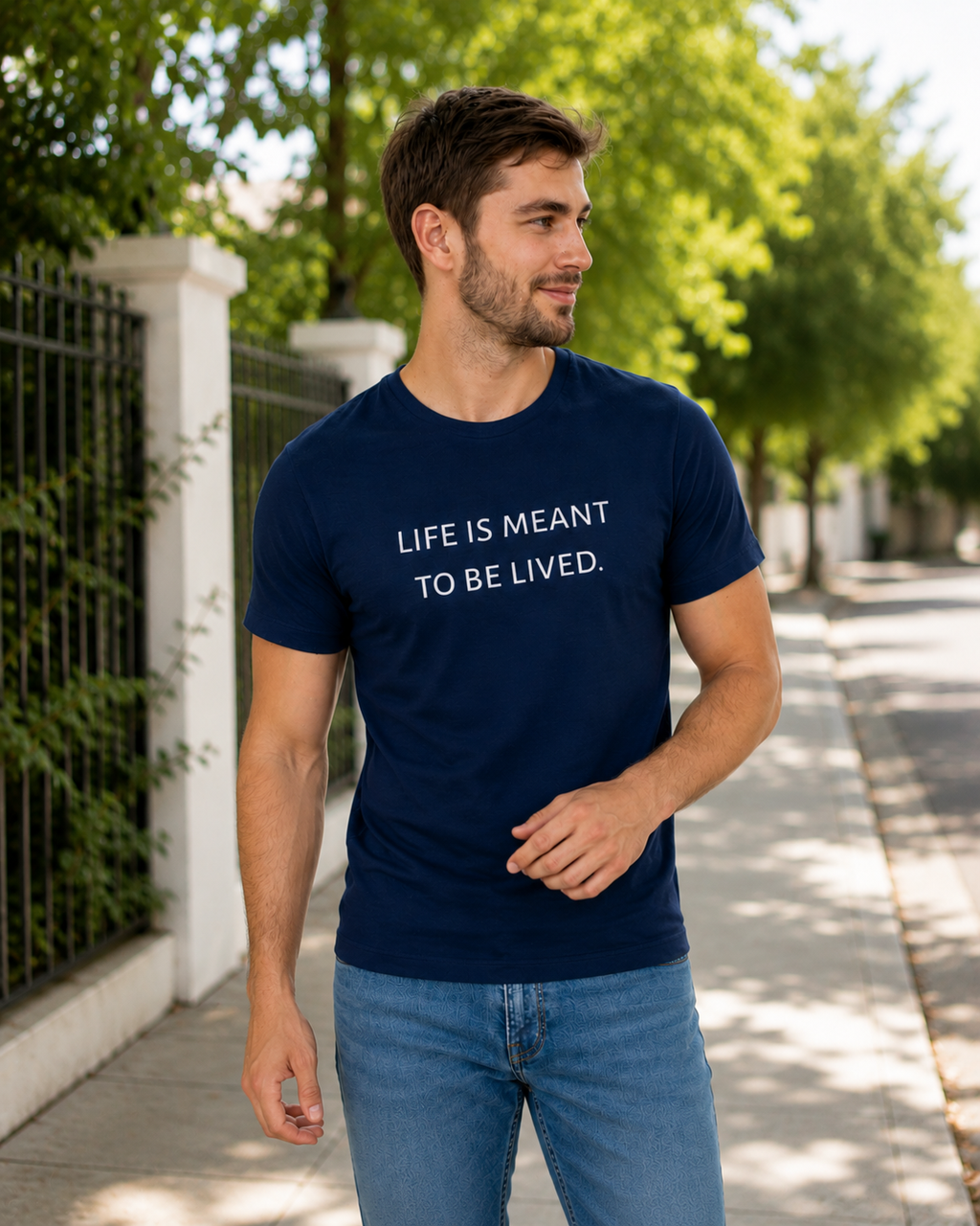 Man wearing a navy blue t-shirt with text in a minimal indoor setting